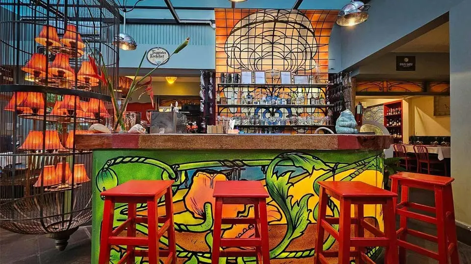The colourful bar with red bar stools at Brussels Bistro Bangkok