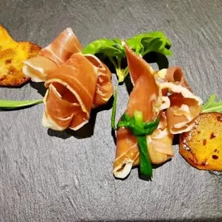 Cured ham rolls served on slate