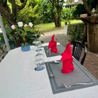 Garden terrace table set with red napkins