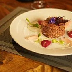Beef tartare plated with edible flowers